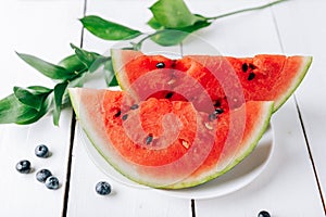 Summer still life of fresh fruit and berries on a white wooden surface