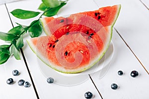 Summer still life of fresh fruit and berries on a white wooden surface