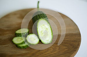 Summer still life with sliced â€‹â€‹cucumber on a board.