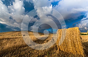 Summer storm looms over hay field in Tuscany, Italy.CR2 photo