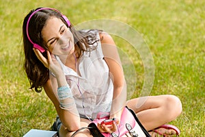 Summer student girl listen music sitting grass