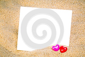 Summer style with empty blank paper Red and Pink Heart Knitting on a sea sand. white card background for add text. Backdrop love