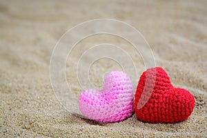 Summer style with Red and Pink Heart Knitting on a sea sand. background for add text. Backdrop love valentine greeting card