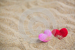 Summer style with Red and Pink Heart Knitting on a sea sand. background for add text. Backdrop love valentine greeting card