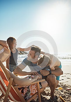 Summer sun means lots of family fun. a happy family of four having fun at the beach.