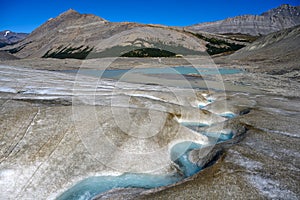 Summer sun melting ice on the Athabasca Glacier in the Jasper National Park, Alberta, Canada photo
