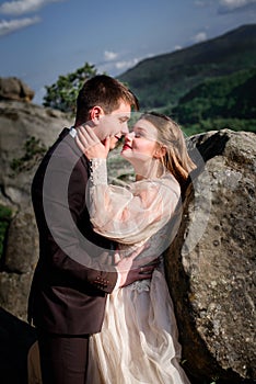 Summer sun shines over the old-fashioned wedding couple