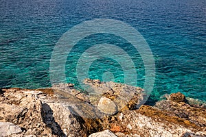 Summer sunny day crystal clear turquoise water and rocky coast of the beautiful Aponissos bay, Agistri island, Saronic Gulf,