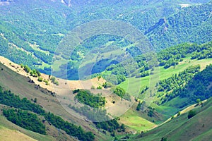 Summer sunny day in the mountains.Green peaks under the rays of the sun