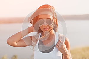 Summer sunny lifestyle fashion portrait of stylish hipster girl