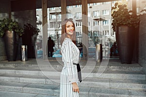 Summer sunny lifestyle fashion portrait of young stylish hipster woman with sunglasses walking on the street, wearing cute trendy