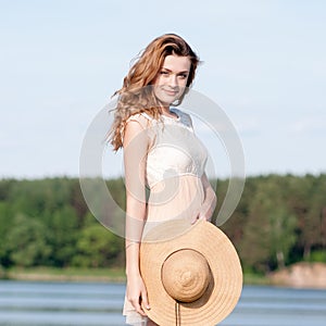 Summer sunny lifestyle fashion portrait of young stylish hipster woman walking on park outdoors, wearing cute trendy outfit, smili