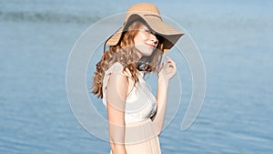 Summer sunny lifestyle fashion portrait of young stylish hipster woman walking on park outdoors, wearing cute trendy outfit, smili