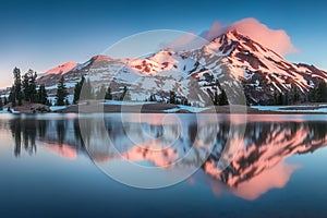 Summer Sunrise South Sister mountains in central Oregon near Bend are reflected in Green Lakes. Mountains in the cascade Range