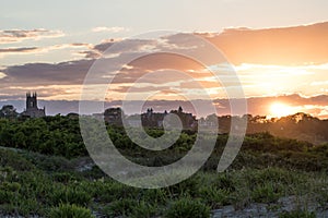 A summer sunset over dune grass in Newport, Rhode Island