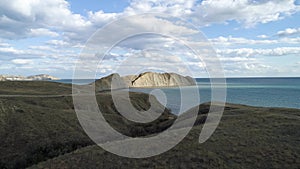 Summer sunset over the valley of rocks, blue ocean, and cloudy sky background, aerial. Shot. Beautiful seascape with