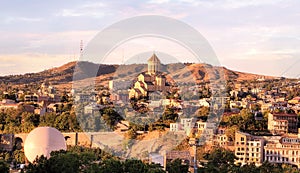 Summer sunset view of the city of Tbilisi Tiflis the capital of Georgia with Holy Trinity Cathedral commonly known as