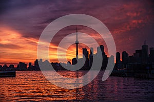 Summer sunset view from Toronto Islands across the Inner Harbour of the Lake Ontario on Downtown Toronto skyline with