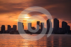 Summer sunset view from Toronto Islands across the Inner Harbour of the Lake Ontario on Downtown Toronto skyline with