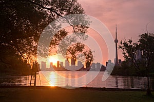 Summer sunset view from Toronto Islands across the Inner Harbour of the Lake Ontario on Downtown Toronto skyline with