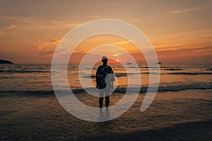 Summer sunset,Woman walking on the beach watching the sunset