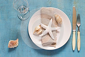 Summer table setting in marine style, decorated with shells