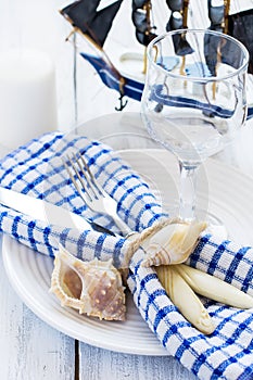Summer table setting in marine style, decorated with shells and