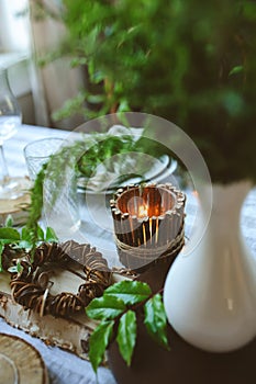 Summer table setting in natural organic style with handmade details in green and brown tones