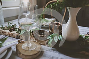 Summer table setting in natural organic style with handmade details in green and brown tones