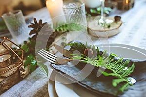 Summer table setting in natural organic style with handmade details in green and brown tones