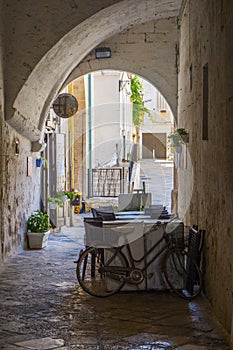Summer terrace cafe in a narrow arched passageway of Polignano a Mare, Italy. photo