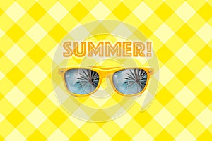 Summer text and yellow sunglasses with palm tree reflections isolated in large pastel yellow grid background