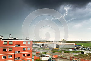 Summer thunderstorm over city buildings