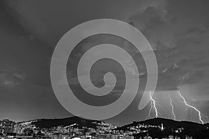 Images of the arrival of a strong summer storm with lightning and rain. Event in the city in the late afternoon, early evening in photo