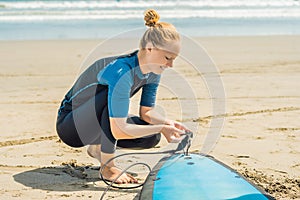 Summer time and active rest concept. Young surfer woman beginner