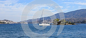 Summer time a beautiful sailboat anchoring in Love bay Eros island or Daskalio near Poros island Greece.