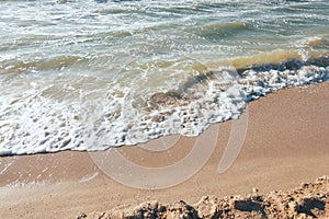 Summer time blue sea waves yellow sun and sand