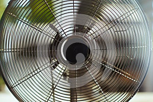 Summer time. Closeup on electric ventilator in office