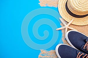 Summer time concept with sea shells and starfish on a blue wooden background and sand