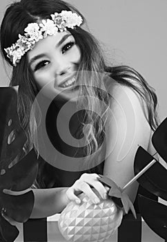 Summer time exotic floral portrait of young beautiful woman with long hair and hair flowers accessorize