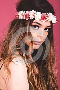 Summer time exotic floral portrait of young beautiful woman with long hair and hair flowers accessorize