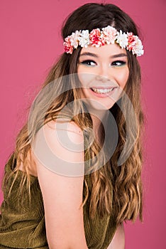 Summer time exotic floral portrait of young beautiful woman with long hair and hair flowers accessorize