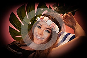 Summer time exotic floral portrait of young beautiful woman with long hair and hair flowers accessorize