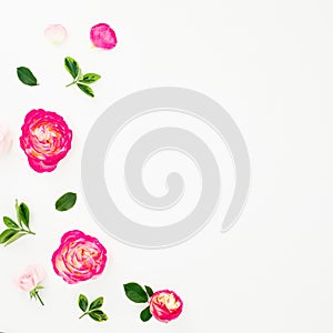 Summer time frame of pastel pink roses flowers and leaves on white background. Flat lay