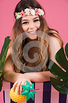 Summer time girl sitting in beach chair  on pink background with copy space