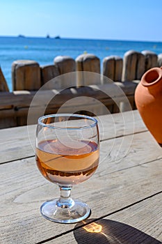 Summer time in Provence, glass of rose wine on bar terrace Pampelonne sandy beach near Saint-Tropez in sunny day, Var department,
