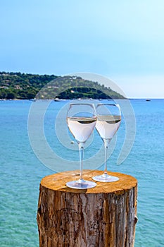 Summer time in Provence, two glasses of cold rose wine on Pampelonne sandy beach near Saint-Tropez in sunny day, Var department,