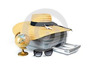 Summer time. Travel accessories with suitcase, straw hat, toy airplane and globe in minimal trip vacation concept isolated on