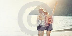 Summer time, Two girls hugging their necks and turning their backs on the beach.