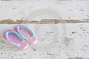 Summer time vacation concept. Beach Accessories shoe on white vintage wooden background